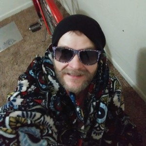 a blanket some sunglasses a red bike and an empty room